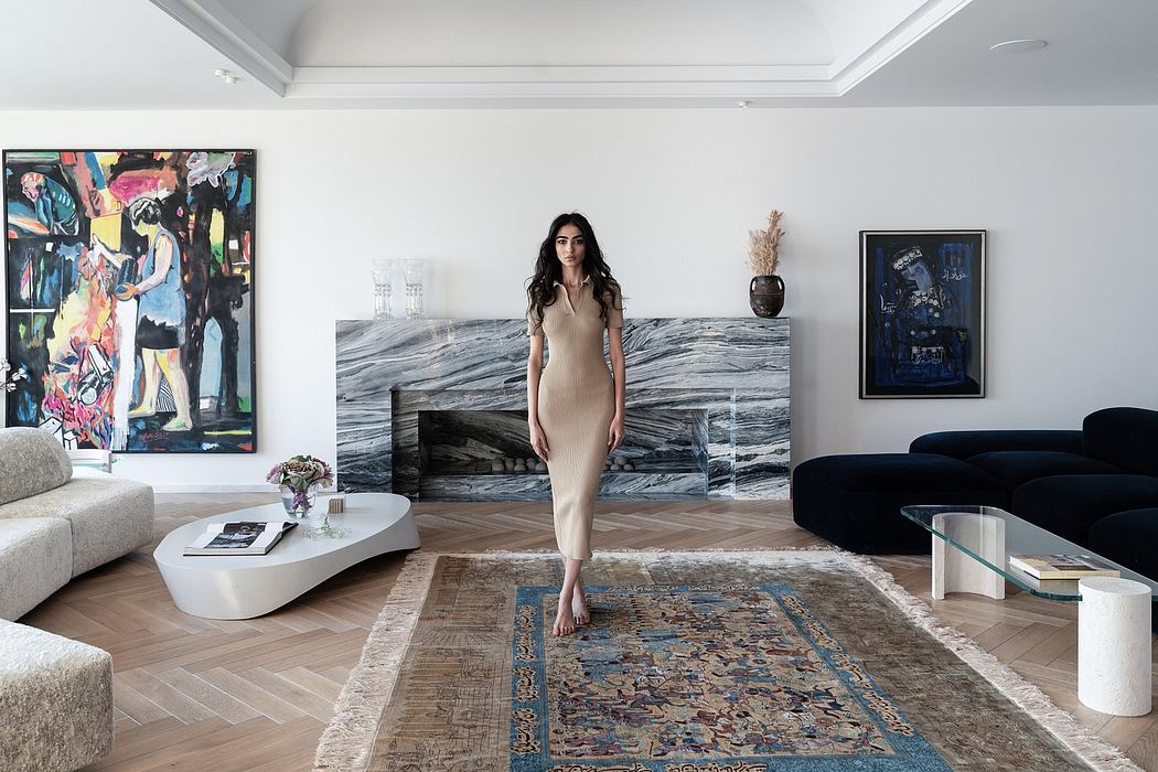 Elegant modern living room with artistic decor, minimalist furniture, and marble fireplace.