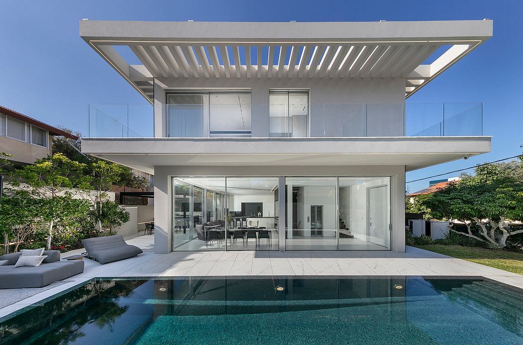Sleek, modern house with open floor plan, stylish outdoor living space, and infinity pool.