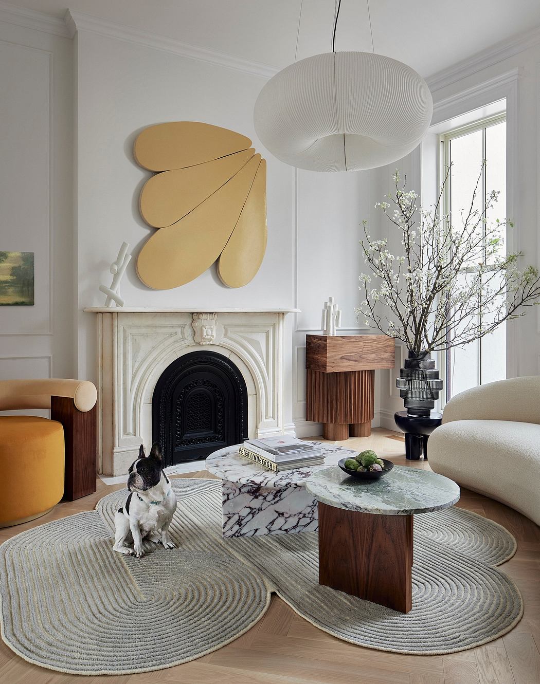 Stylish interior design featuring a fireplace, modern light fixture, and a dog.