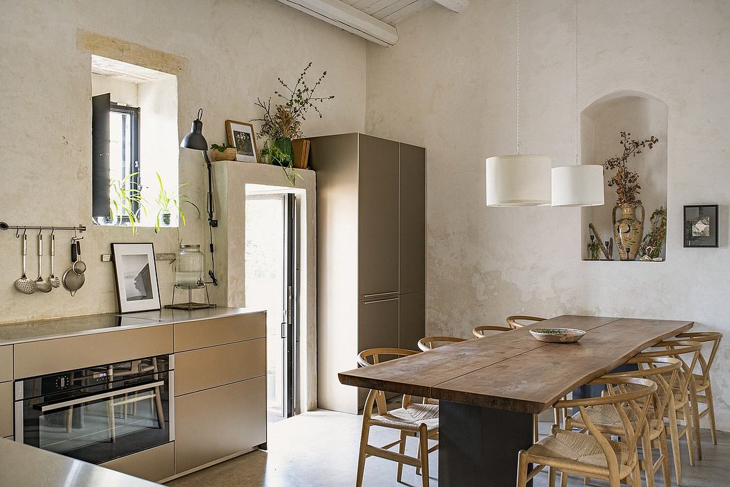 Rustic, minimalist kitchen-dining area with wood furnishings, shelving, and lighting fixtures.