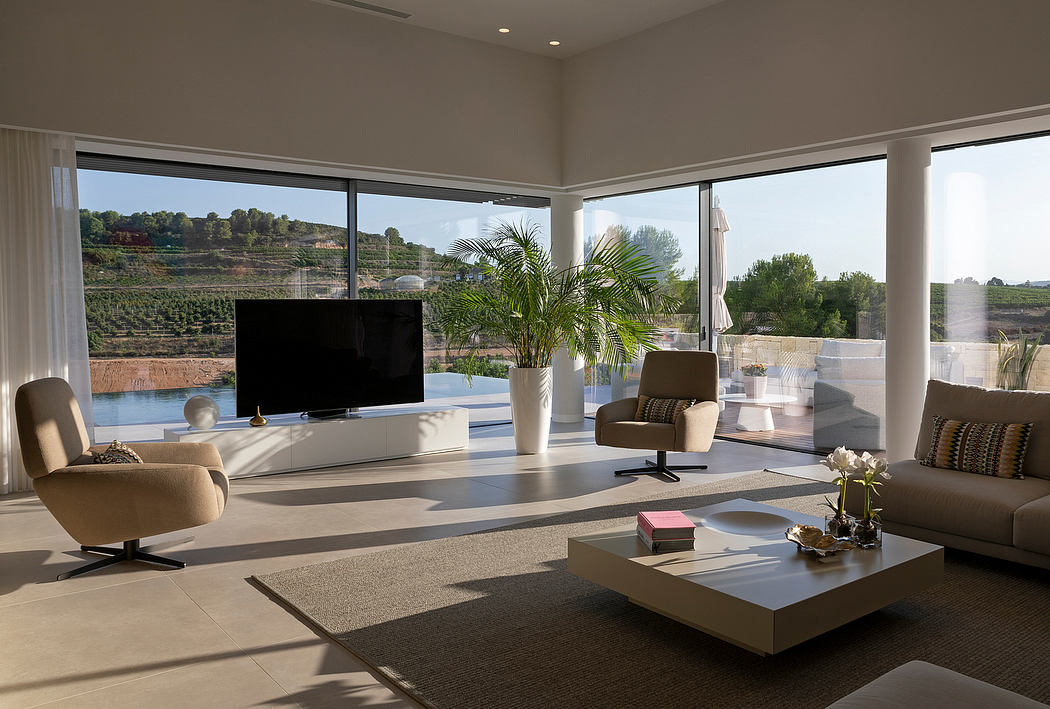 Sleek, modern living space with floor-to-ceiling windows offering scenic outdoor views.