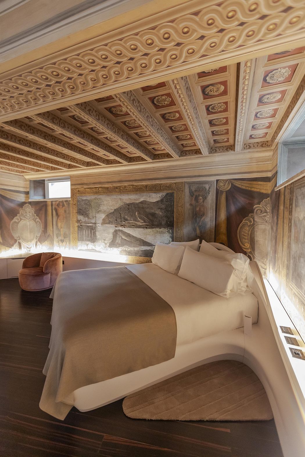 An ornate, elaborately decorated bedroom with a carved, patterned wooden ceiling and wall panels.