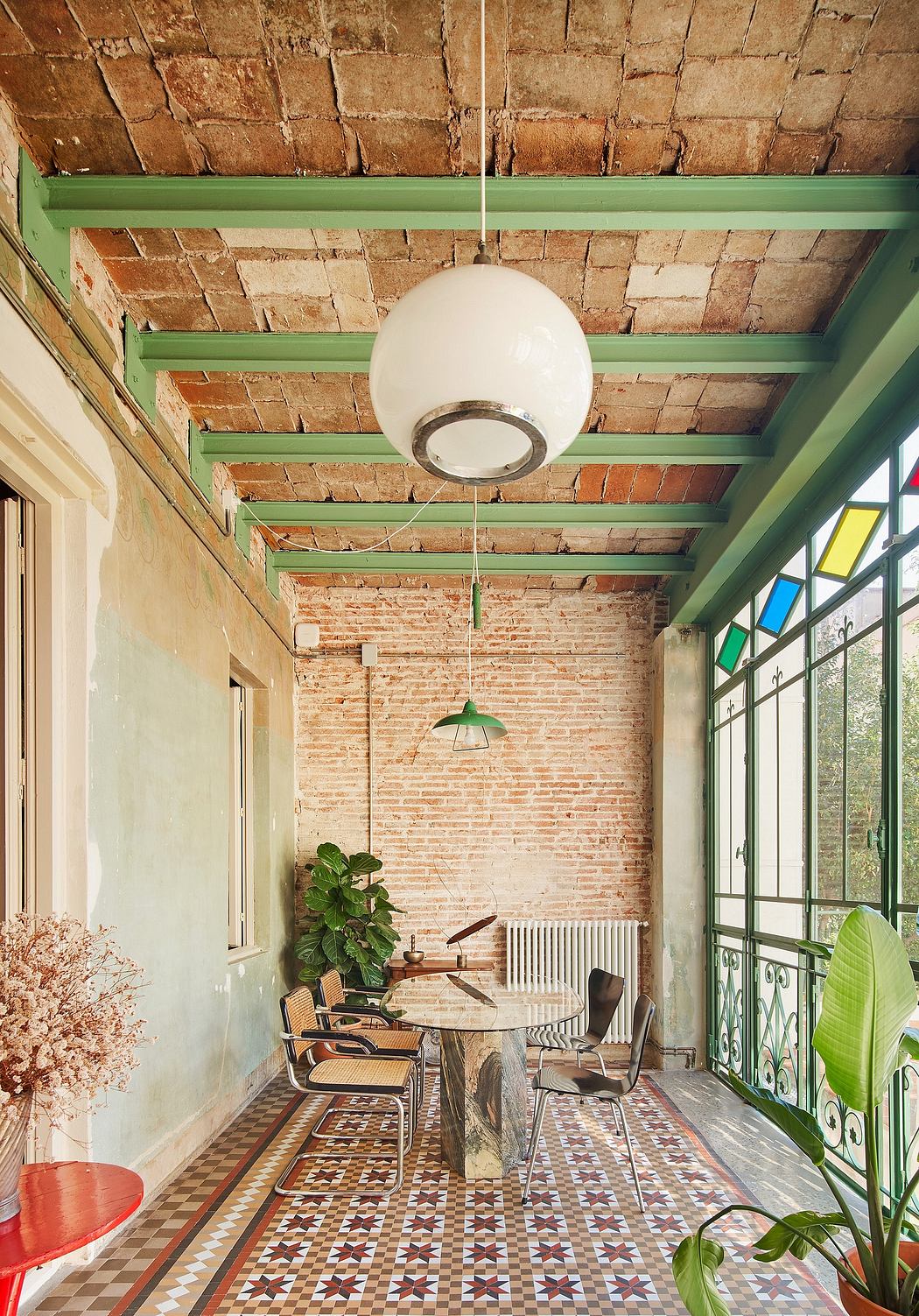 Cozy brick-walled interior with patterned floor tiles, wood furnishings, and vibrant accents.