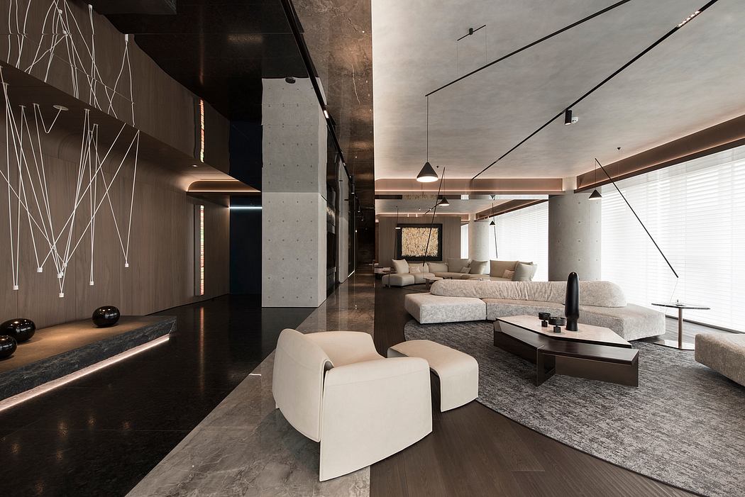 Modern, minimalist living room with concrete walls, sleek furniture, and lighting fixtures.