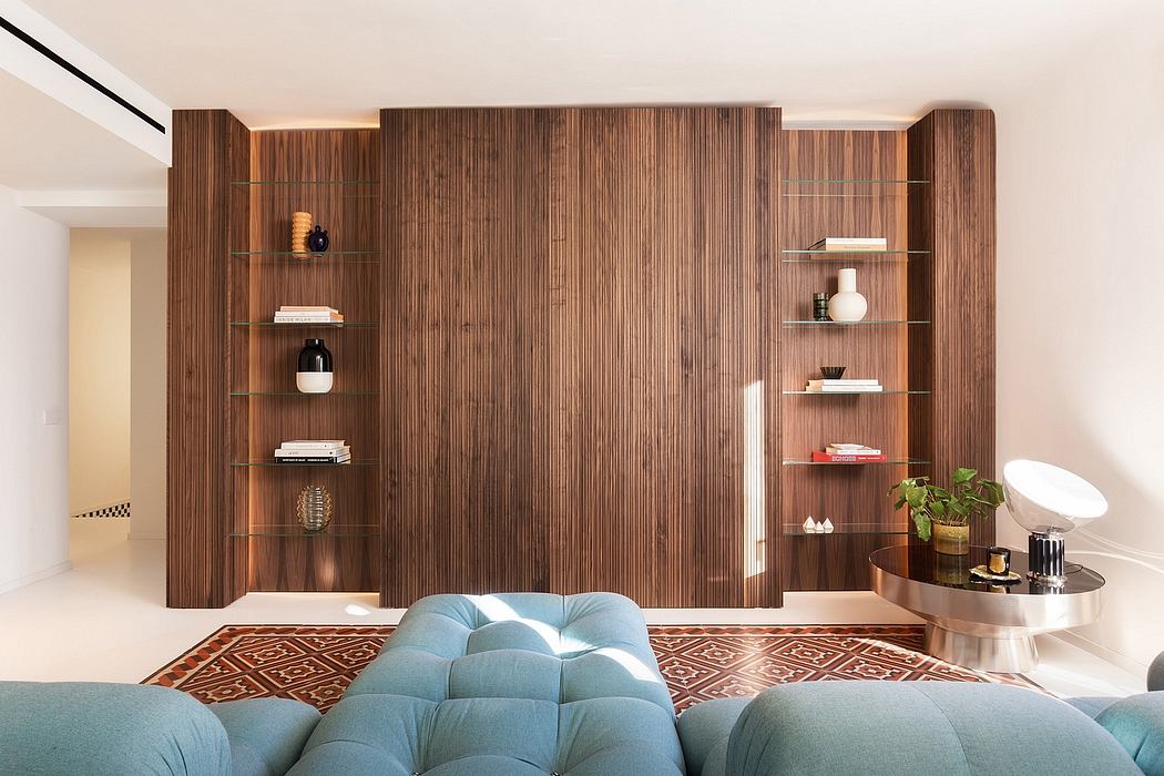 Spacious modern living room with warm wooden wall paneling, built-in shelves, and plush seating.