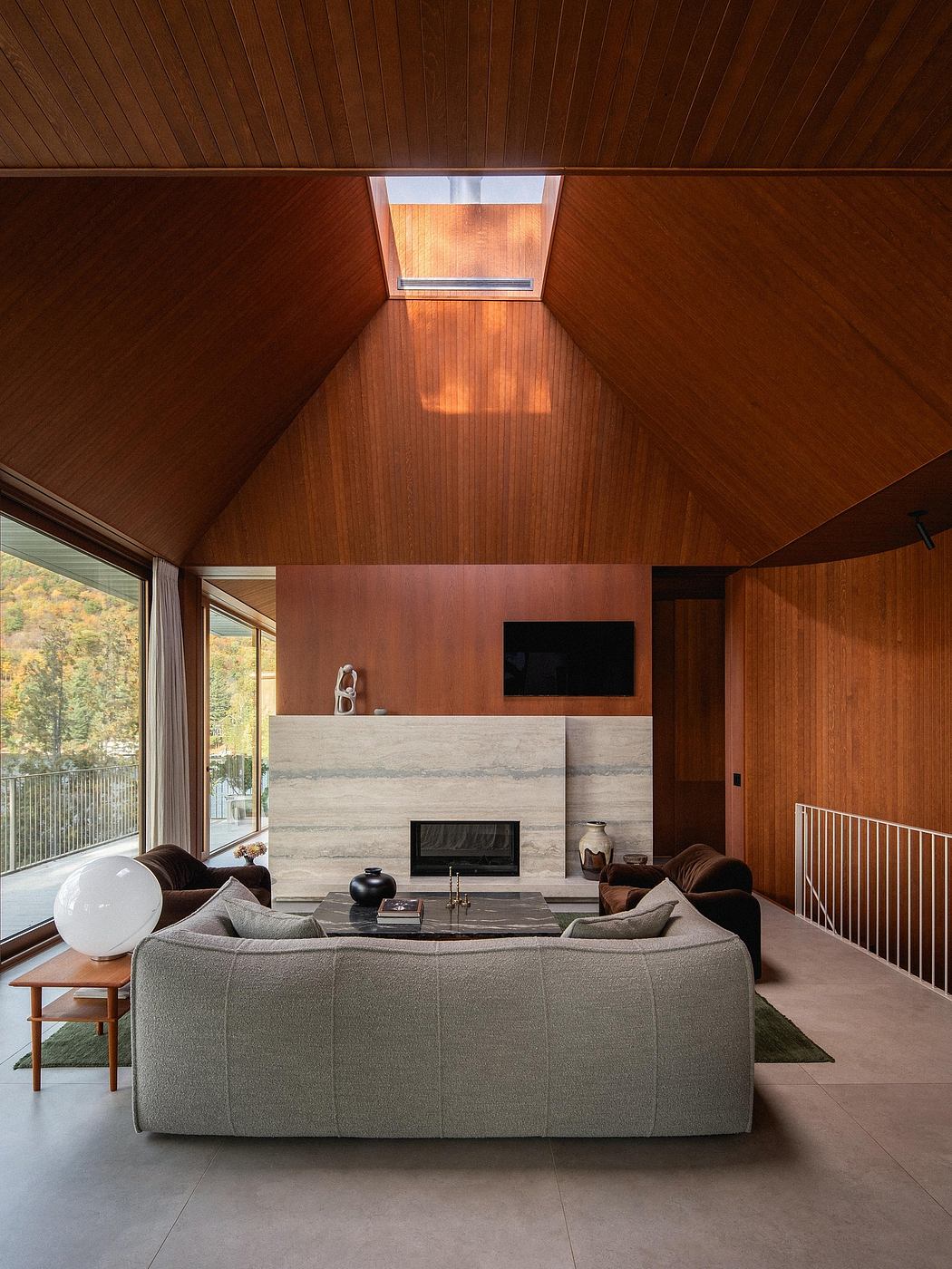 Spacious modern living room with wooden ceiling, concrete fireplace, and large windows.