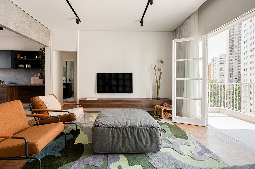 Bright, modern living room with minimalist furniture, wooden TV stand, and patterned rug.