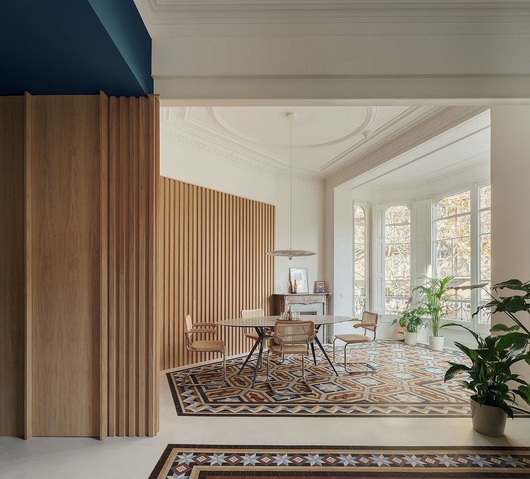 Elegant entry with ornate moldings, wooden wall paneling, and patterned tile floor.