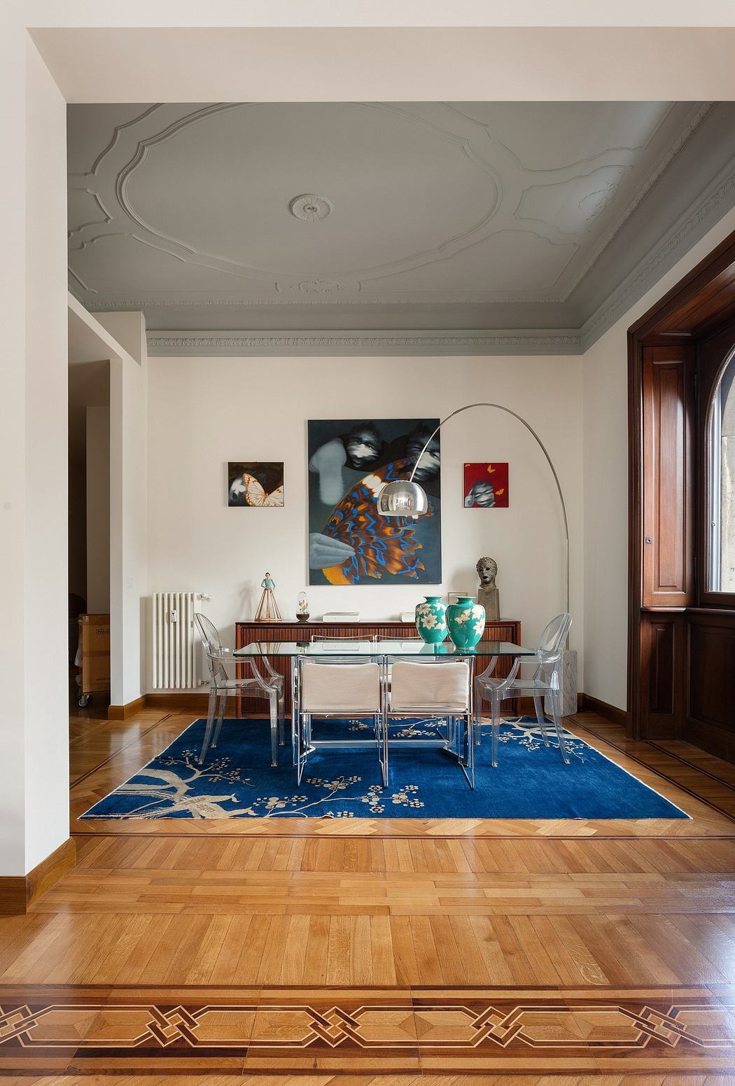 Ornate ceiling, intricate rug, modern decor blend seamlessly in this elegant room.