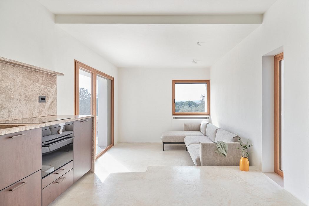 Bright, modern open-plan living space with minimalist design, wood accents, and large windows.