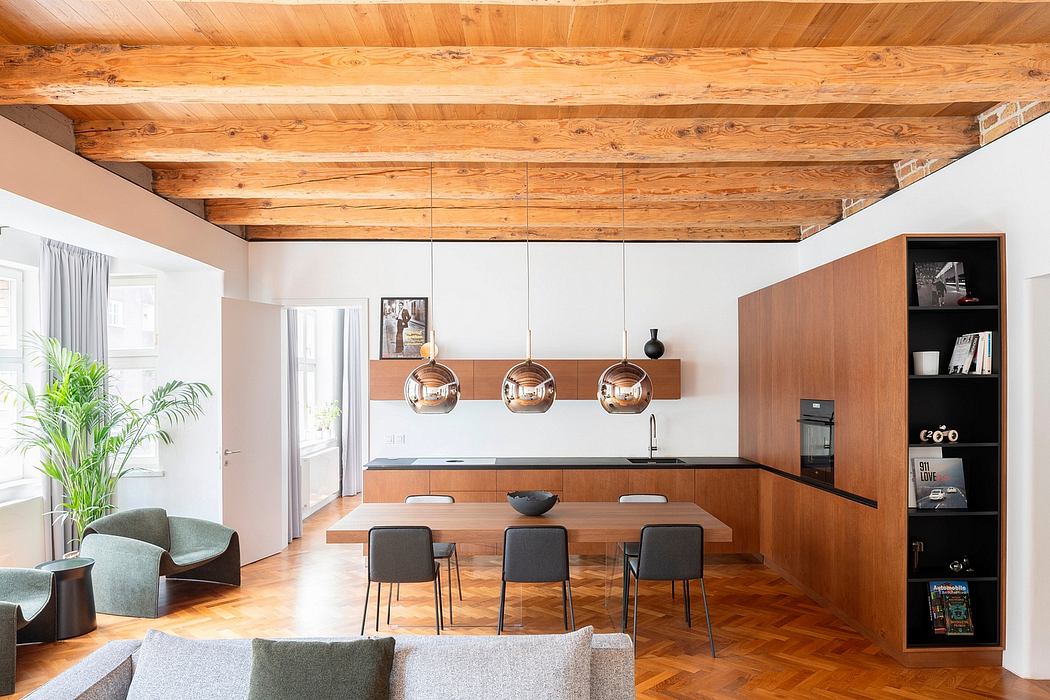 Warm, modern kitchen with exposed wood beams, pendant lights, and sleek cabinetry.