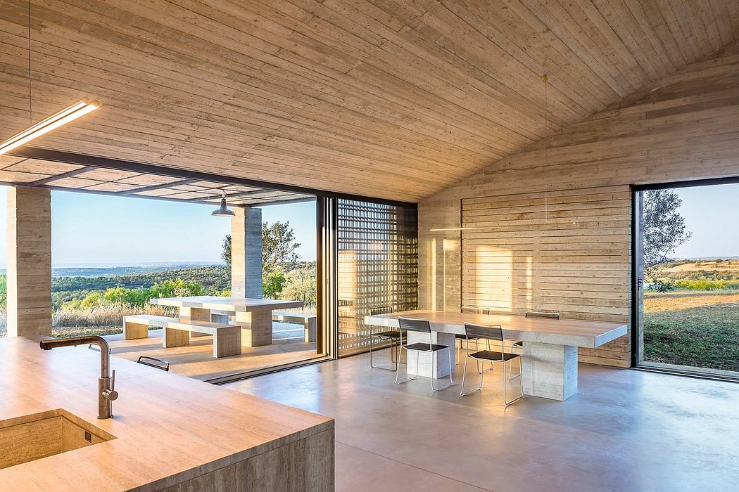 Rustic wooden interior with large windows, open floor plan, and modern furnishings.