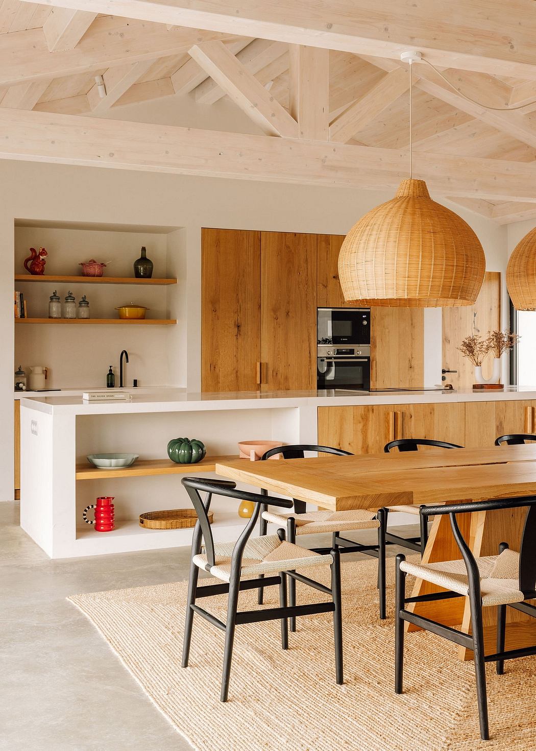 Modern rustic kitchen with wooden beams, built-in cabinets, and woven pendant lights.