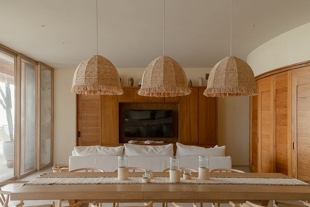 Warm, natural-toned living room with woven pendant lights, wooden cabinetry, and plush seating.
