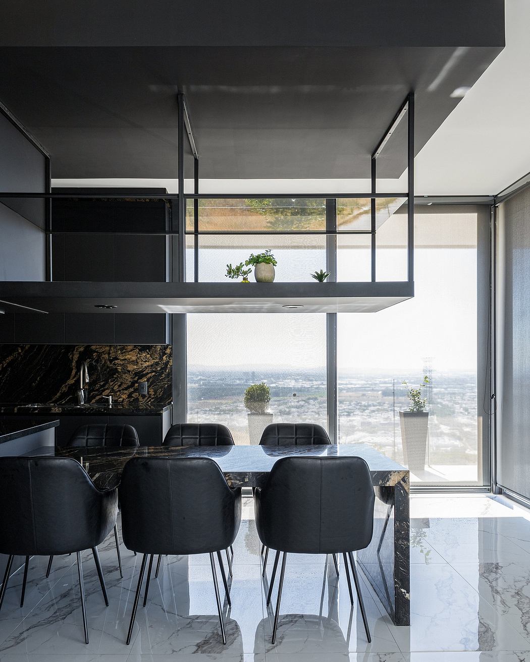 Sleek, modern kitchen with floor-to-ceiling windows showcasing stunning city views.