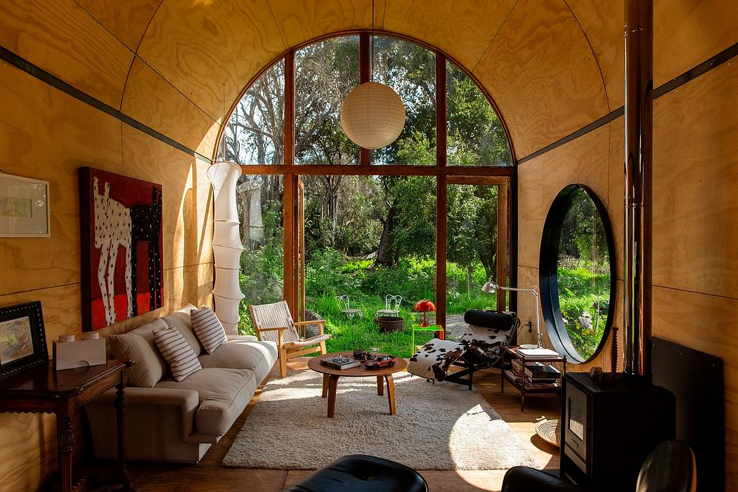 Cozy living room with large arched windows overlooking lush greenery, organic textures.