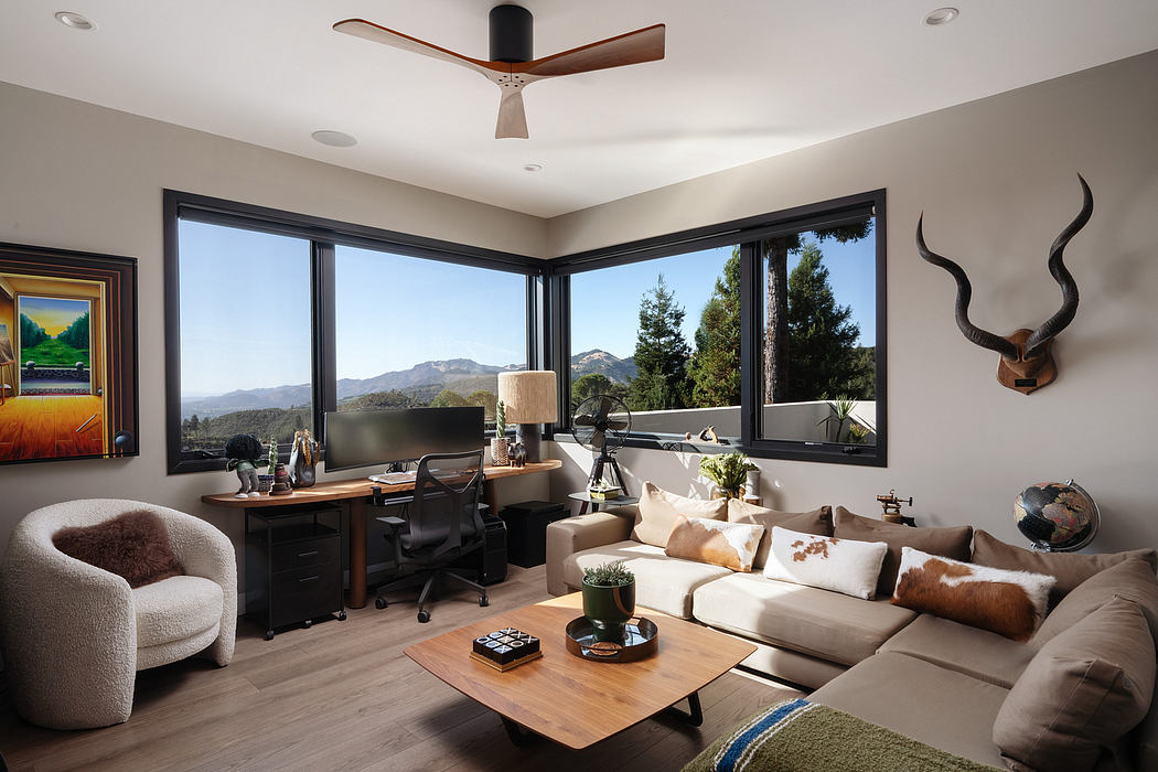 Spacious living room with floor-to-ceiling windows, modern furnishings, and nature views.