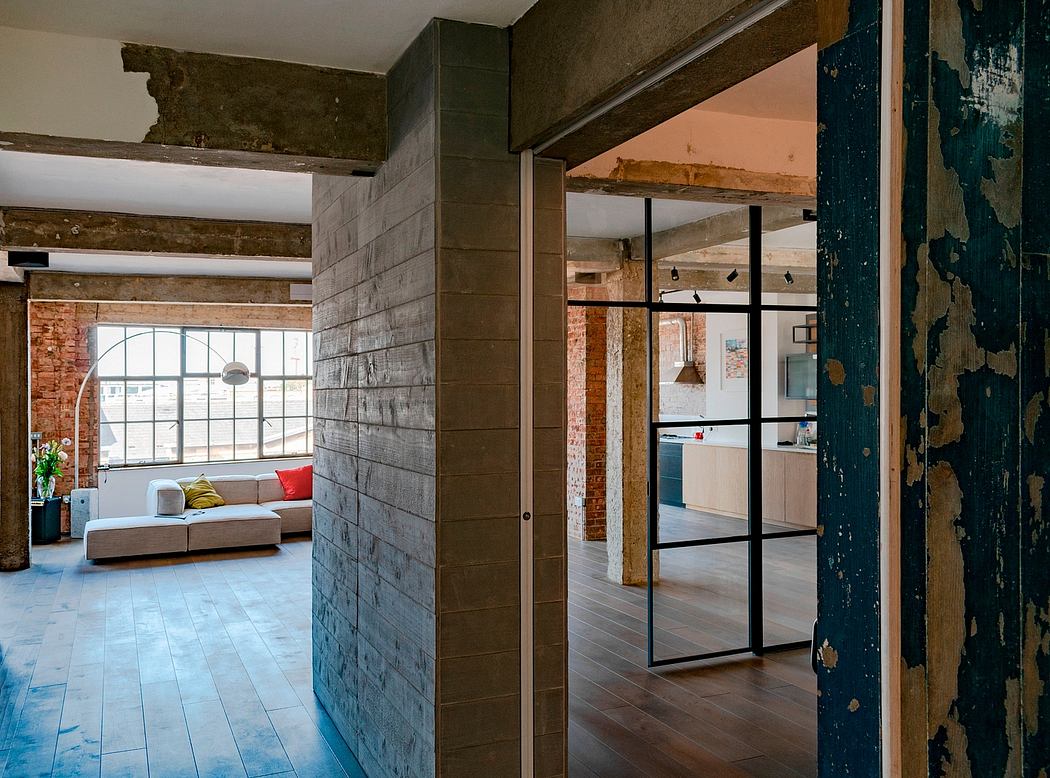 Rustic warehouse loft with exposed brick walls, wooden beams, and industrial-style windows.
