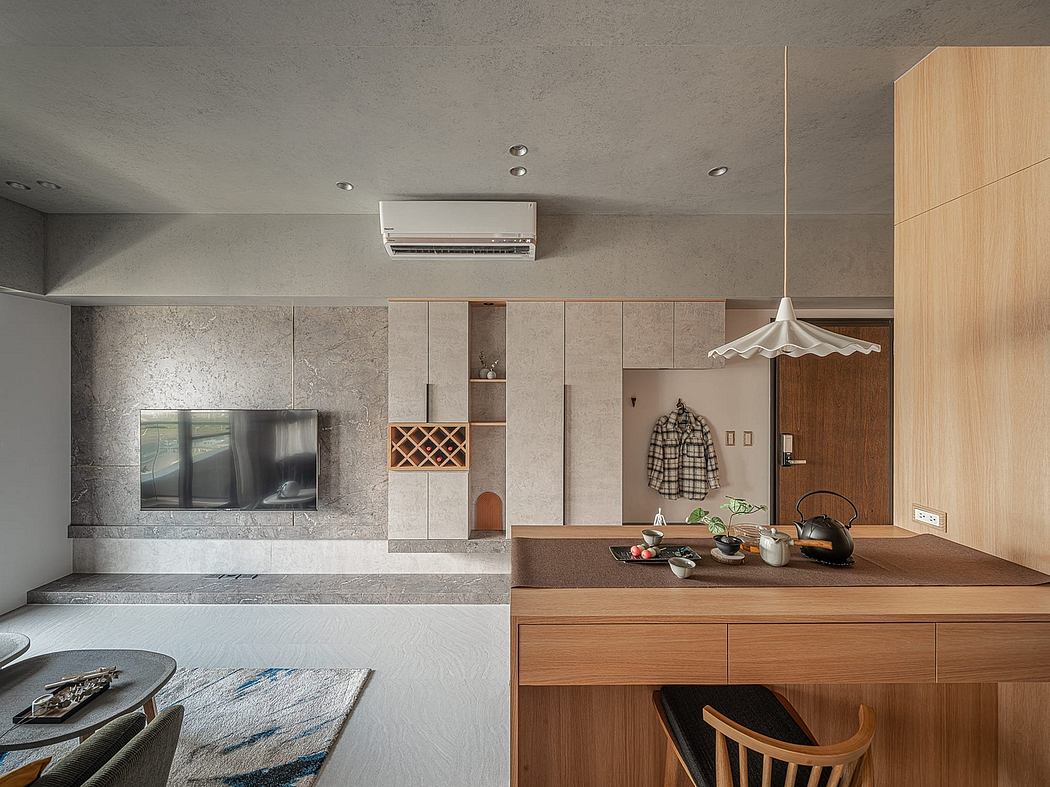 Modern, minimalist apartment with sleek kitchen, built-in storage, and natural wood accents.