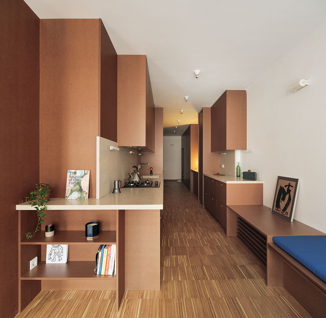 A minimalist kitchen and living space defined by warm wood tones and clean lines.