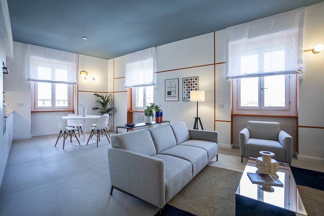 Bright, modern living room with minimalist furnishings, large windows, and neutral color palette.