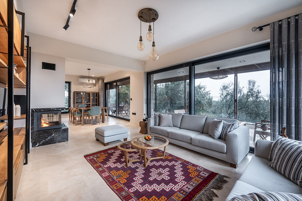 Spacious open-concept living area with modern lighting, plush sofa, and patterned area rug.