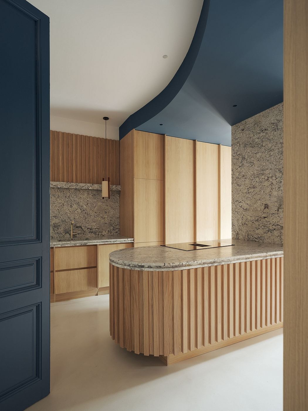 Sleek kitchen with natural wood cabinetry, stone countertops, and minimalist design.