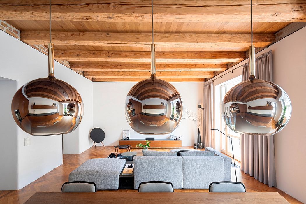 Cozy, rustic living room with wooden beamed ceiling and modern pendant lights.