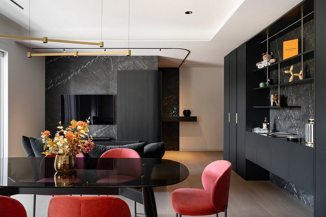A modern, chic living area with sleek black furniture, marble accents, and vibrant pops of color.
