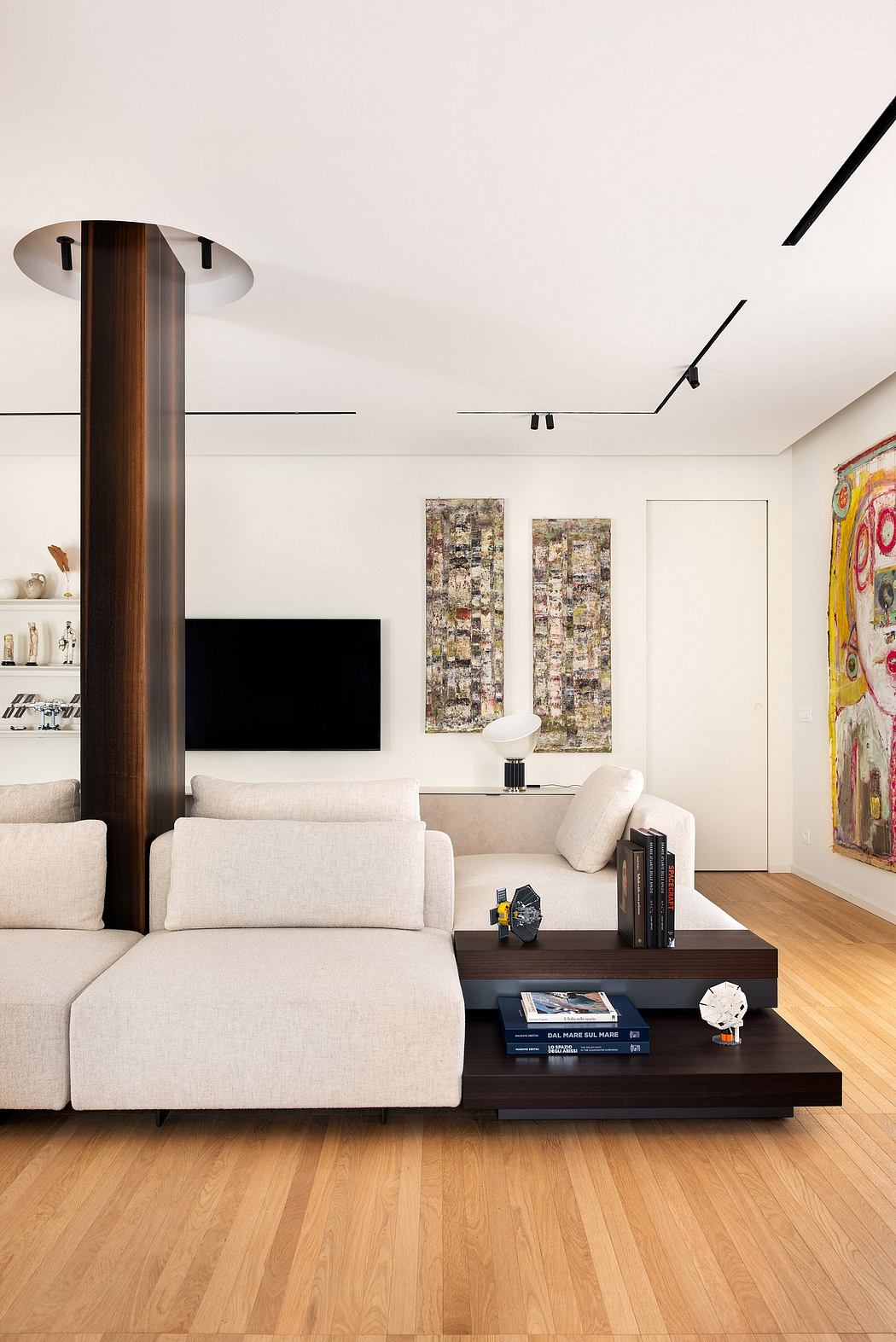 A sleek, modern living room with minimalist furniture, artwork, and wooden accents.
