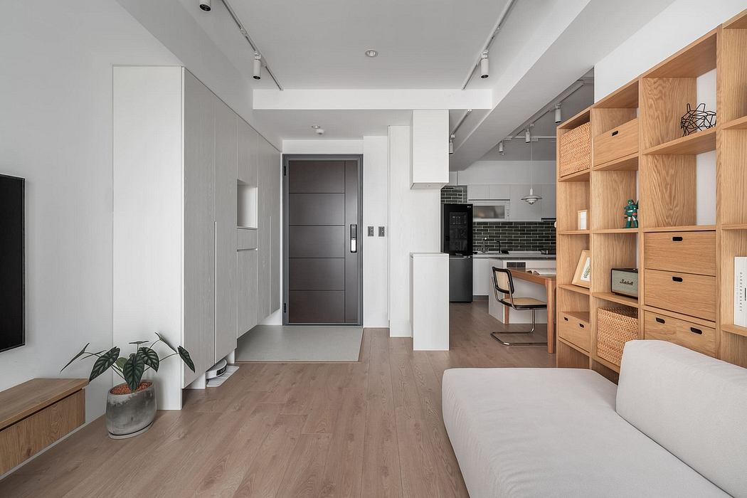 Spacious modern apartment with minimalist design, natural wood accents, and built-in shelves.
