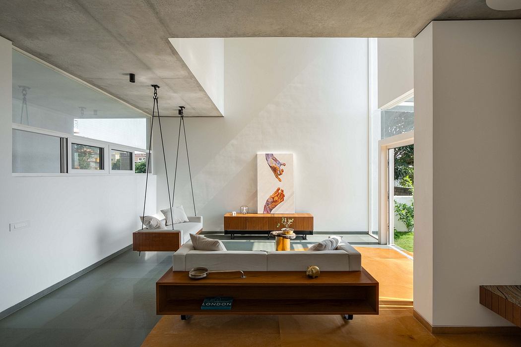 A modern, minimalist living room with wooden furniture, large windows, and a minimalist artwork.
