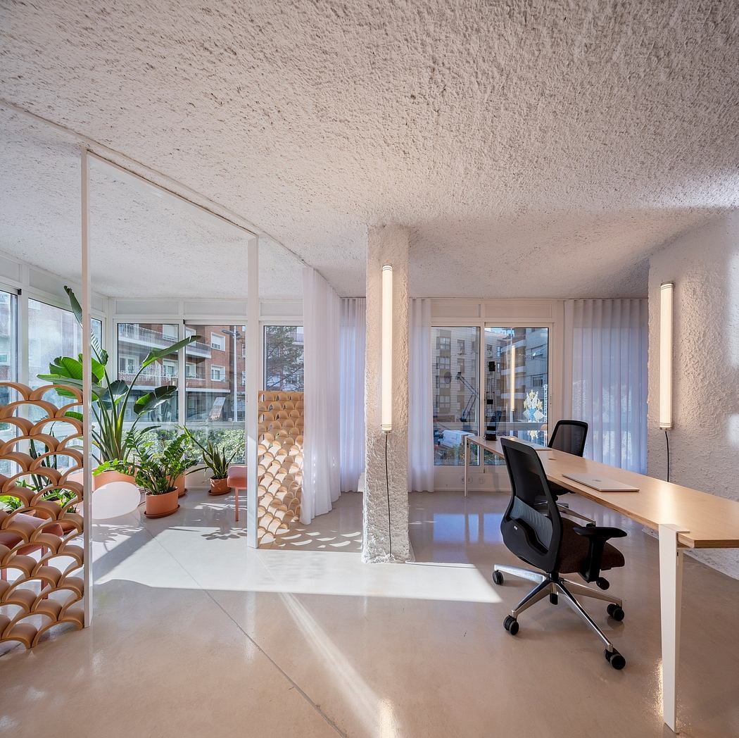A modern office space with large windows, wood-paneled walls, and a minimalist desk setup.