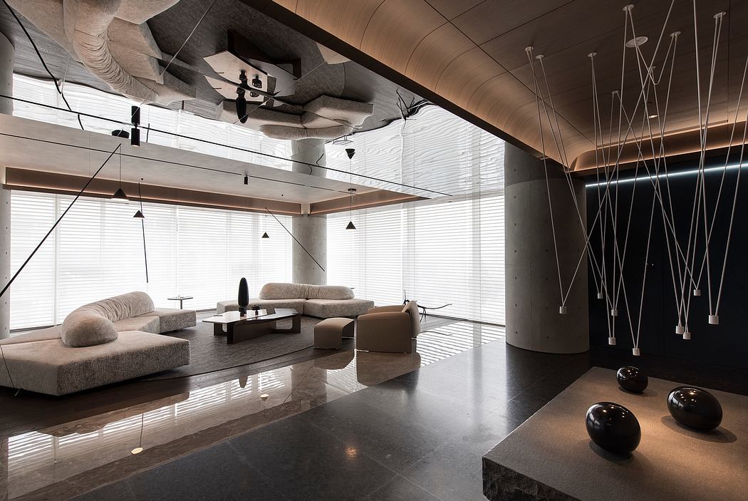 A modern, minimalist interior design with sleek furniture, lighting fixtures, and polished concrete floors.