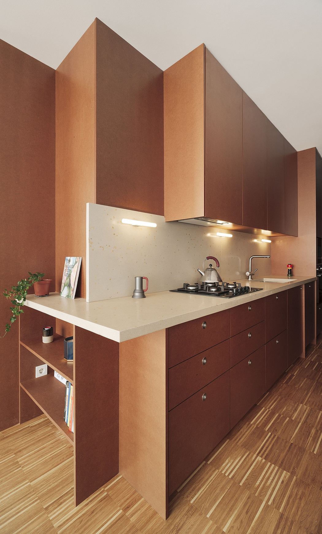 Modern kitchen with sleek brown cabinetry, white countertop, and recessed lighting.