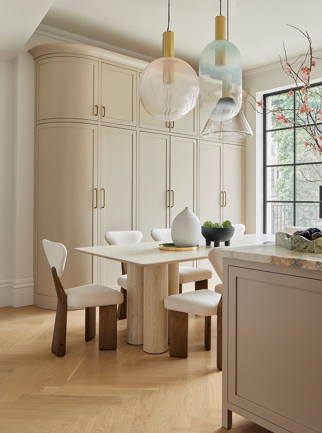 Elegant kitchen with neutral tones, built-in cabinetry, and sleek pendant lighting.