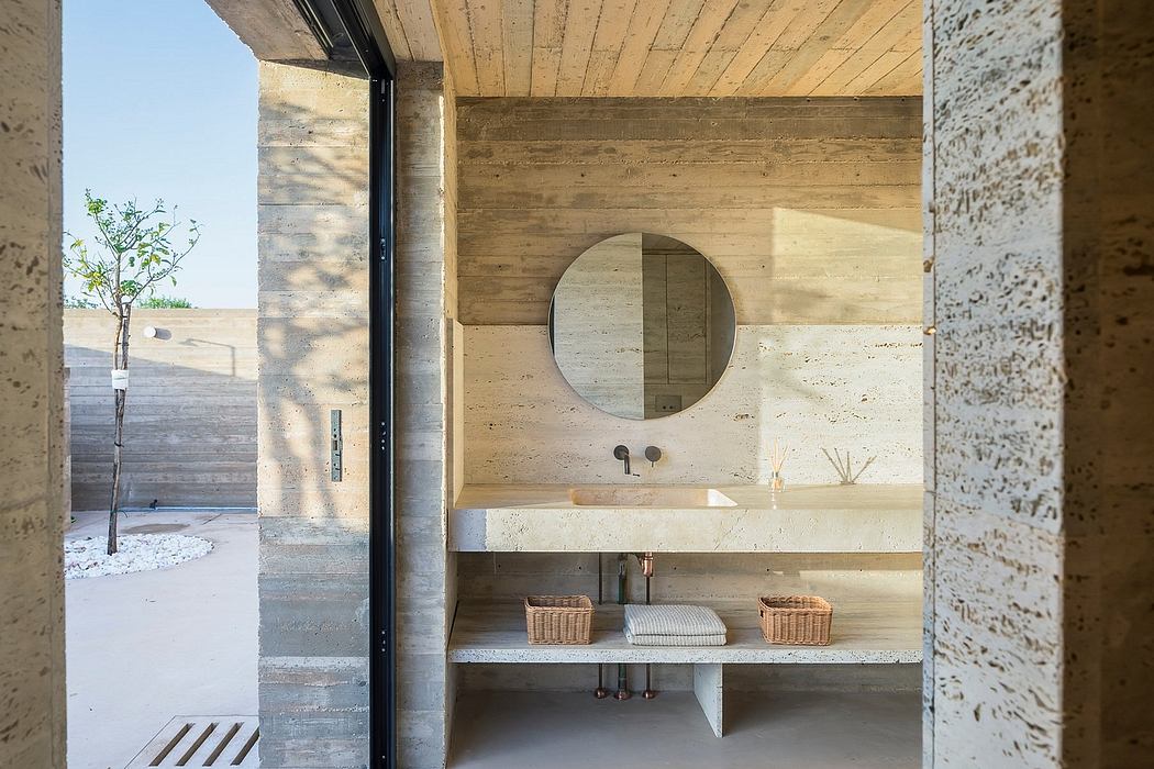 A rustic bathroom with wood paneling, round mirror, and open shelves displaying decorative items.