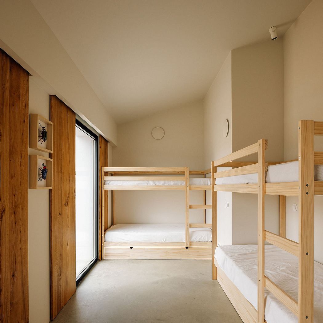 Minimalist bunk bed setup with wooden frame and sliding glass door in a spacious room.