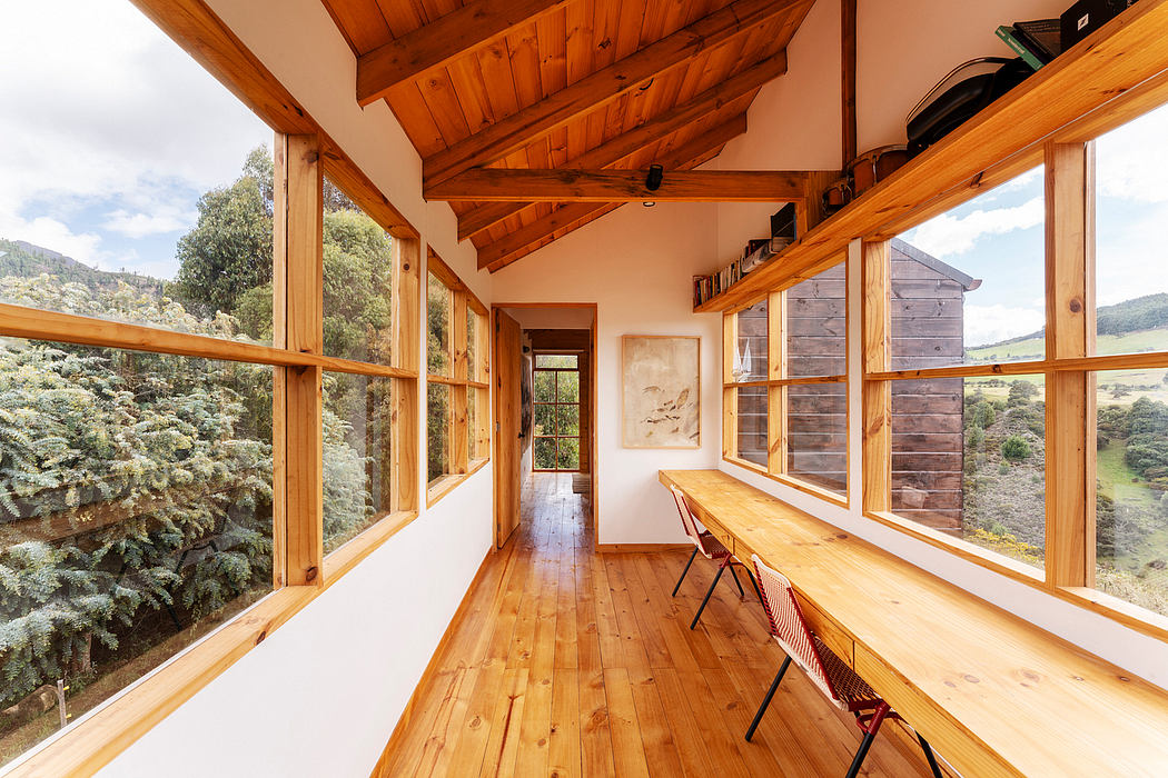 A rustic wooden cabin with expansive windows, showcasing a scenic mountain landscape.