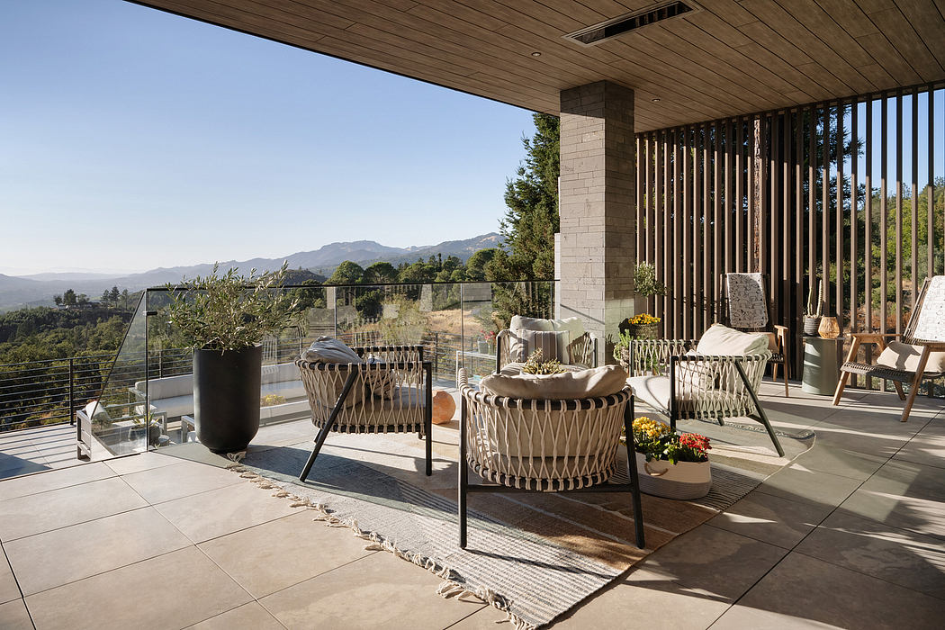 Sleek modern patio with wood ceiling, metal railings, and plush outdoor furniture.