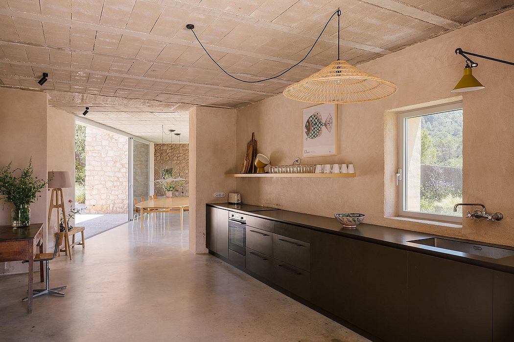 Rustic kitchen with exposed beams, shelves, and large windows offering scenic views.