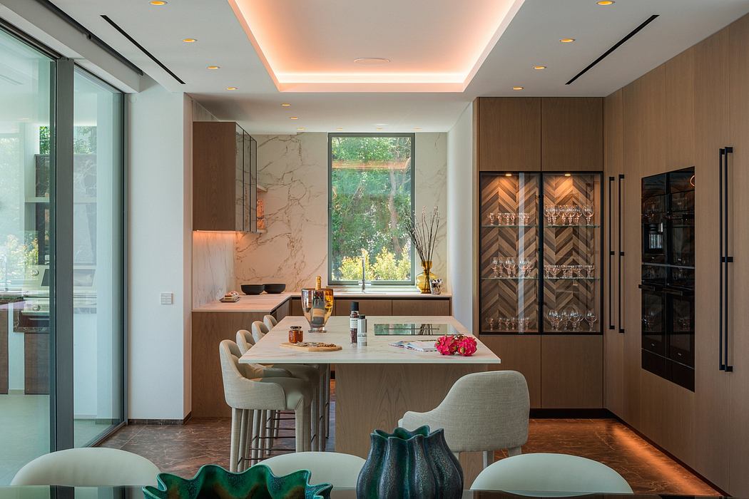 Sleek modern kitchen with marble countertops, wood cabinetry, and a cozy dining area.