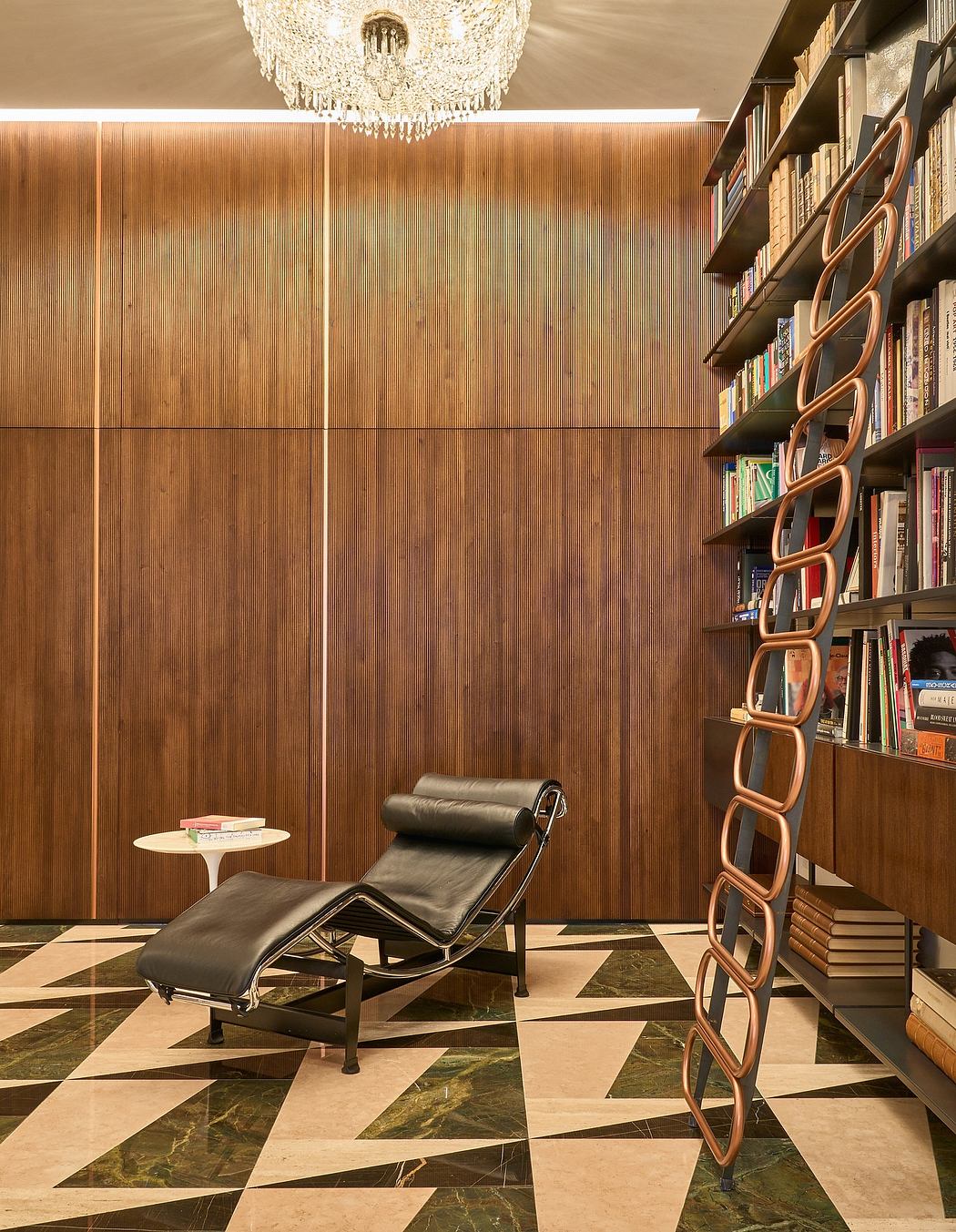 Luxurious library with wood paneling, chandelier, and minimalist chaise lounge on patterned marble floor.