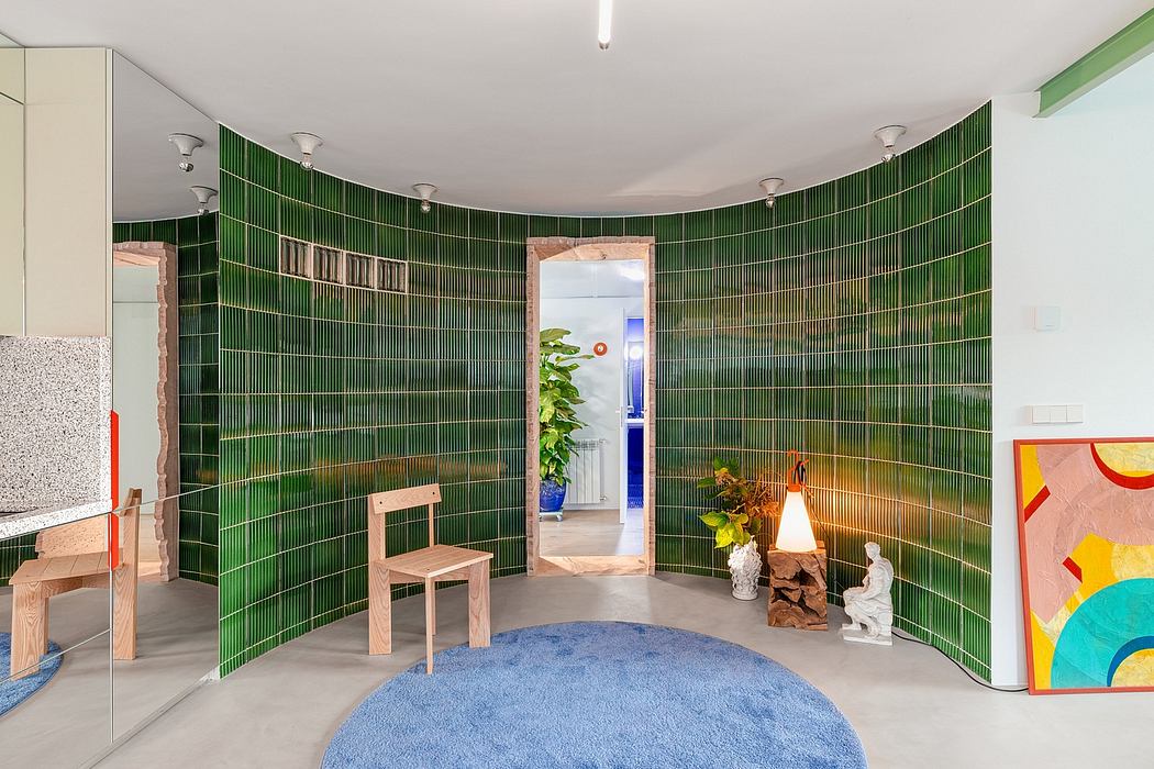 A circular room with vibrant green tiles, wooden furniture, and abstract artwork.
