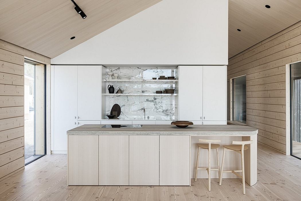 Minimalist kitchen with white cabinetry, marble backsplash, and wooden floor and ceiling.