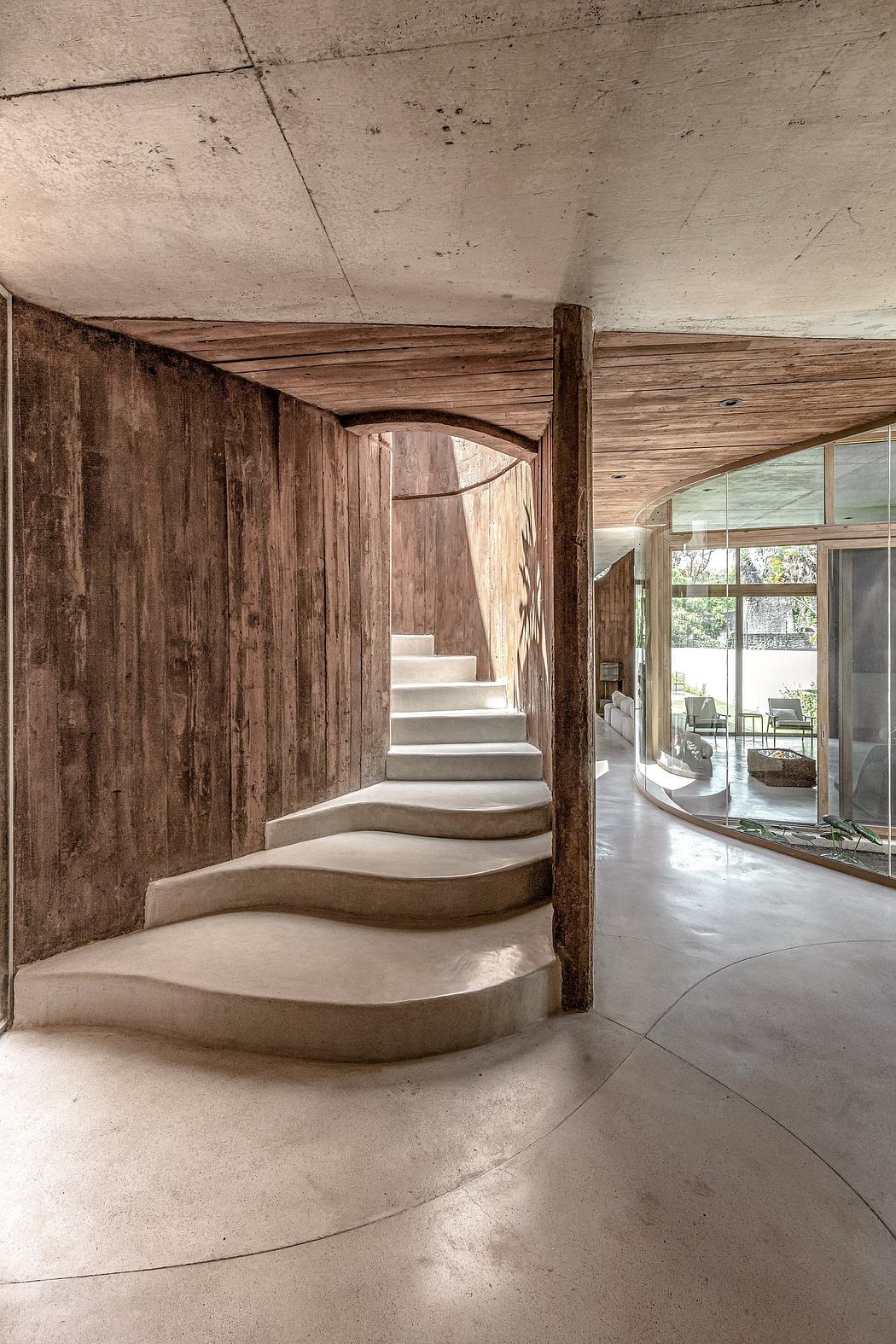 A rustic, wooden staircase leads to a bright, modern living space with large windows.