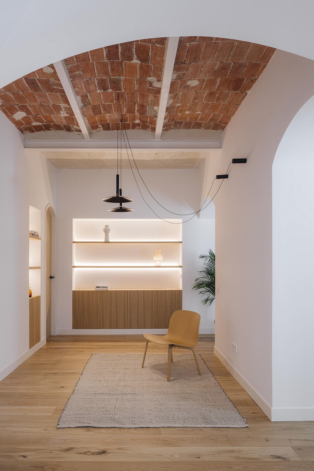 A vaulted brick ceiling creates a warm, cozy atmosphere in this modern interior.