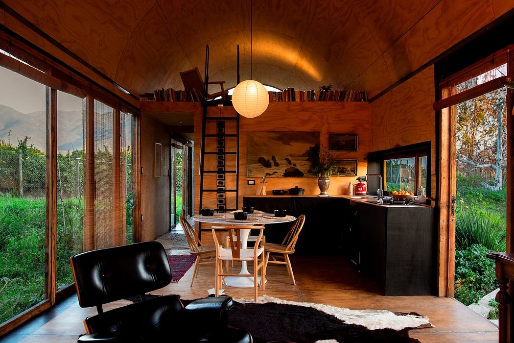 A cozy, rustic interior with wooden beams, a lantern, and a beautiful landscape view through the windows.