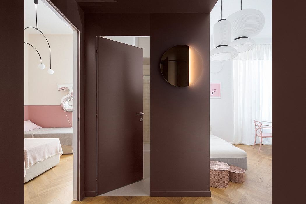 Elegant modern interior with geometric light fixtures, rounded mirror, and textured surfaces.