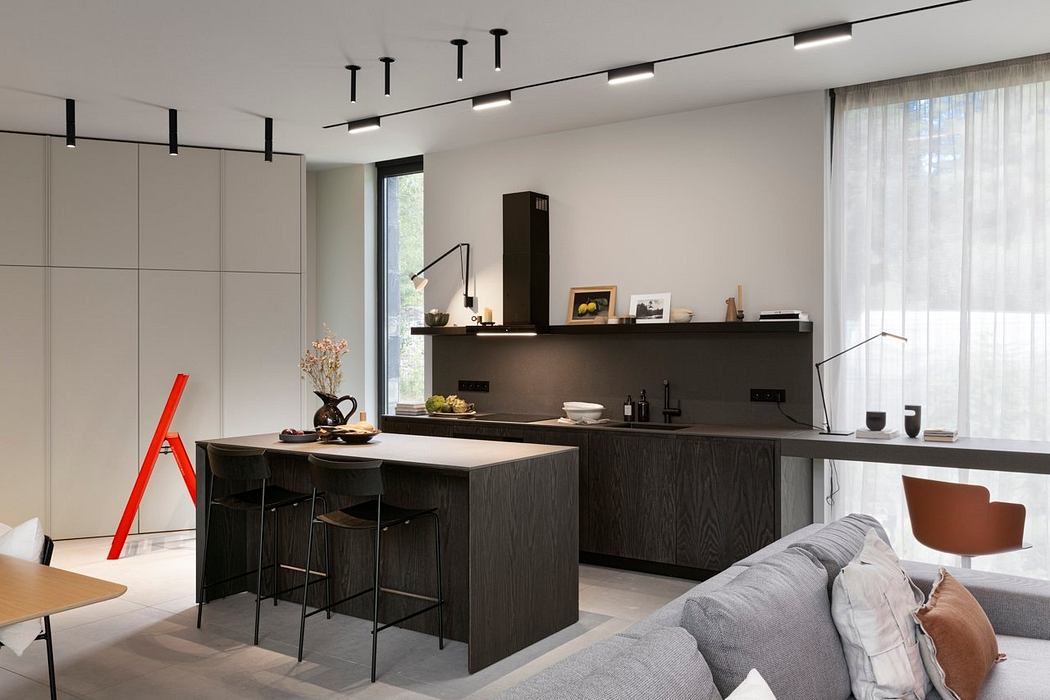 Minimalist kitchen with dark wood cabinetry, sleek lighting, and a large window offering natural light.